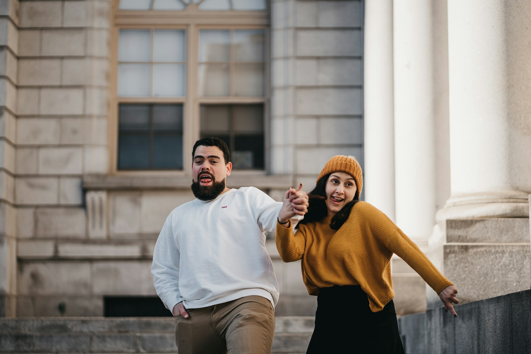 Frank and his wife smiling outside of a beautiful building